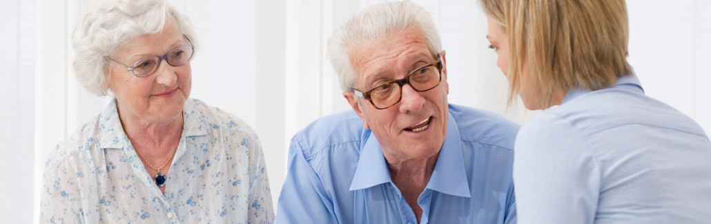 Elderly couple meeting advisor about aged care assistance.